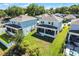 Aerial view showcasing screened patios, green lawns, and backyard in a residential area at 1123 Dora Parc Ln, Mount Dora, FL 32757