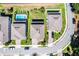 Aerial view of properties with in-ground pools and the street showing driveways and yards at 1123 Dora Parc Ln, Mount Dora, FL 32757