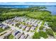 An aerial view presents a vibrant lakeside community with lush greenery at 1123 Dora Parc Ln, Mount Dora, FL 32757