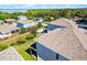 Aerial view of rooftops with screened patios, green lawns, and neighborhood landscape at 1123 Dora Parc Ln, Mount Dora, FL 32757