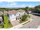 Beautiful two-story home showcasing manicured landscaping, brick driveway, and proximity to the lake at 1123 Dora Parc Ln, Mount Dora, FL 32757