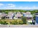 Aerial view of the community with lush tree coverage and a lake in the background at 1123 Dora Parc Ln, Mount Dora, FL 32757