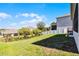 Well-maintained backyard and green space featuring a view of a neighboring home at 1123 Dora Parc Ln, Mount Dora, FL 32757