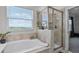 Spa bathroom showcasing a large tub, tiled shower with glass door and a great view at 1123 Dora Parc Ln, Mount Dora, FL 32757