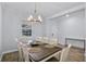 Dining room featuring a wooden table, chandelier lighting, and wood-look flooring at 1123 Dora Parc Ln, Mount Dora, FL 32757