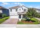 Charming home with a brick driveway and front porch seating at 1123 Dora Parc Ln, Mount Dora, FL 32757