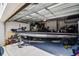Well-organized garage featuring a sleek Phoenix bass boat on a trailer at 1123 Dora Parc Ln, Mount Dora, FL 32757