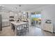 Well-lit kitchen with an island, stainless appliances, and sliding doors to the deck at 1123 Dora Parc Ln, Mount Dora, FL 32757