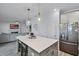 Bright open kitchen featuring a modern island, stylish decor, and stainless appliances at 1123 Dora Parc Ln, Mount Dora, FL 32757