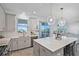 Gourmet kitchen with stainless appliances, island with bar stools, and great natural light at 1123 Dora Parc Ln, Mount Dora, FL 32757