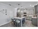 Modern kitchen with island, stainless steel appliances, and stylish pendant lighting at 1123 Dora Parc Ln, Mount Dora, FL 32757