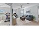 Living room with ceiling fan, light blue walls, and a glimpse into a home gym at 1123 Dora Parc Ln, Mount Dora, FL 32757