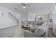Spacious living room with hardwood floors and an expansive sectional sofa at 1123 Dora Parc Ln, Mount Dora, FL 32757