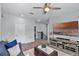 Living room with wood-look flooring, a flat-screen television, and modern decor at 1123 Dora Parc Ln, Mount Dora, FL 32757