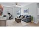 Inviting living room featuring light blue walls, a ceiling fan, and a glimpse of a home gym at 1123 Dora Parc Ln, Mount Dora, FL 32757