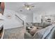 Spacious living room featuring a cozy fireplace and stairs leading to the second floor at 1123 Dora Parc Ln, Mount Dora, FL 32757