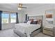 Comfortable main bedroom featuring carpet, a large window, fan and neutral decor at 1123 Dora Parc Ln, Mount Dora, FL 32757