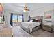 Spacious main bedroom with carpet, large window with view, a fan and neutral walls at 1123 Dora Parc Ln, Mount Dora, FL 32757