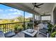 Relaxing patio with comfortable seating and outdoor plants overlooking the backyard at 1123 Dora Parc Ln, Mount Dora, FL 32757