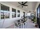 Relaxing covered patio featuring an outdoor dining table, ceiling fans, and views at 1123 Dora Parc Ln, Mount Dora, FL 32757