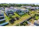 Aerial view of the home's backyard featuring a pool, green grass, and some trees at 1123 Dora Parc Ln, Mount Dora, FL 32757
