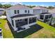 Rear exterior of the home features a covered and screened-in patio with a grill at 1123 Dora Parc Ln, Mount Dora, FL 32757