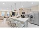 Stylish kitchen with a large island, breakfast bar, stainless steel appliances, and seamless transition to living area at 11360 Blue Bay Dr, Orlando, FL 32832