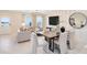 Bright, open-concept living room features a modern chandelier, dining area, and stylish decor at 11360 Blue Bay Dr, Orlando, FL 32832