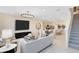Spacious open-concept living area with modern furnishings connects to the dining area and kitchen at 11360 Blue Bay Dr, Orlando, FL 32832
