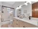 Elegant bathroom with double sink vanity, marble countertop, and glass-enclosed shower at 1166 Adair Park Pl, Orlando, FL 32804