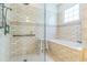 Bright bathroom with white tile walk in shower and tub at 1166 Adair Park Pl, Orlando, FL 32804