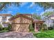 Charming home with a red brick driveway, a red tile roof, and shuttered windows at 1166 Adair Park Pl, Orlando, FL 32804