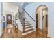 Bright foyer with wood floors and stairs with iron railing at 1166 Adair Park Pl, Orlando, FL 32804