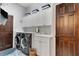 Well-equipped laundry room featuring a utility sink, modern washer and dryer, and ample storage at 1166 Adair Park Pl, Orlando, FL 32804