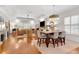 Open concept living room featuring hardwood floors, a dining table, and natural light at 1166 Adair Park Pl, Orlando, FL 32804