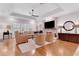 Bright living room with hardwood floors and stone fireplace and large screen television at 1166 Adair Park Pl, Orlando, FL 32804