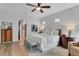 Bright main bedroom with wood floors and white bedding and a seating area at 1166 Adair Park Pl, Orlando, FL 32804