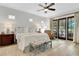 Bright main bedroom with wood floors and a seating area with sliders to the outside at 1166 Adair Park Pl, Orlando, FL 32804
