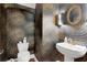Elegant powder room with patterned wallpaper and a pedestal sink at 1166 Adair Park Pl, Orlando, FL 32804