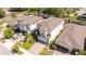 An aerial view showcases the house, highlighting its roof, landscaping, and proximity to neighboring homes at 1311 Arisha Dr, Kissimmee, FL 34746