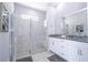 Elegant bathroom with large glass shower, granite countertops, and double vanity sinks at 1311 Arisha Dr, Kissimmee, FL 34746