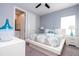 Cozy bedroom with modern decor, white furniture, and ensuite bathroom access at 1311 Arisha Dr, Kissimmee, FL 34746