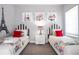 Charming bedroom featuring two twin beds, striped headboards, and cute wall art at 1311 Arisha Dr, Kissimmee, FL 34746