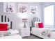 Comfortable bedroom featuring two beds with striped headboards and bright, cheery artwork at 1311 Arisha Dr, Kissimmee, FL 34746
