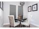 Cozy dining area with round table, upholstered chairs, neutral carpet, and modern lighting at 1311 Arisha Dr, Kissimmee, FL 34746