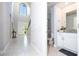 The foyer has an arched window, tile floors and leads to a half bathroom at 1311 Arisha Dr, Kissimmee, FL 34746