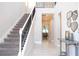 Inviting foyer with staircase, iron railing, tile flooring, and view into the dining area at 1311 Arisha Dr, Kissimmee, FL 34746