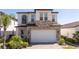 Two-story home featuring stone accents, attached two car garage and a brick paver driveway at 1311 Arisha Dr, Kissimmee, FL 34746