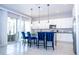 Modern kitchen with white cabinets, gray countertops, stainless steel appliances, and island seating at 1311 Arisha Dr, Kissimmee, FL 34746