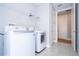 Bright laundry room features modern washer and dryer, plus convenient shelving at 1311 Arisha Dr, Kissimmee, FL 34746